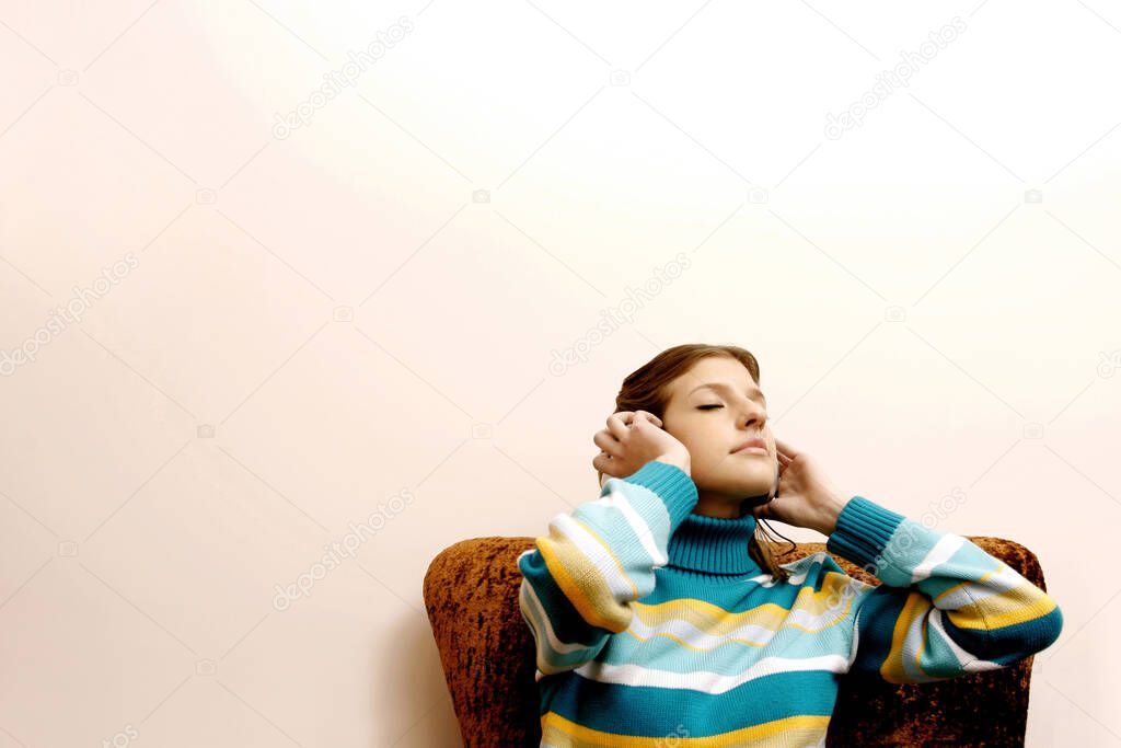 Teenage girl listening to music on the headphones