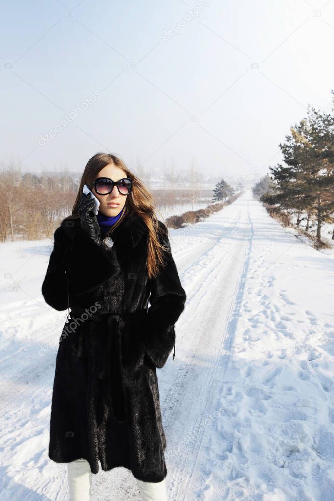 Businesswoman with sunglasses talking on the phone