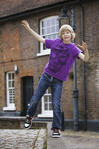 Young Boy Balancing Himself Stock Photo