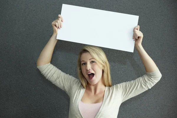 Woman holding a blank placard