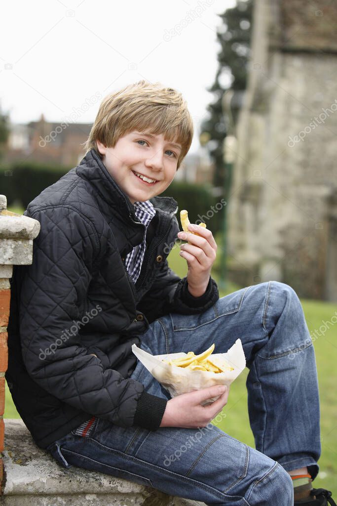 Boy with a pack of fries