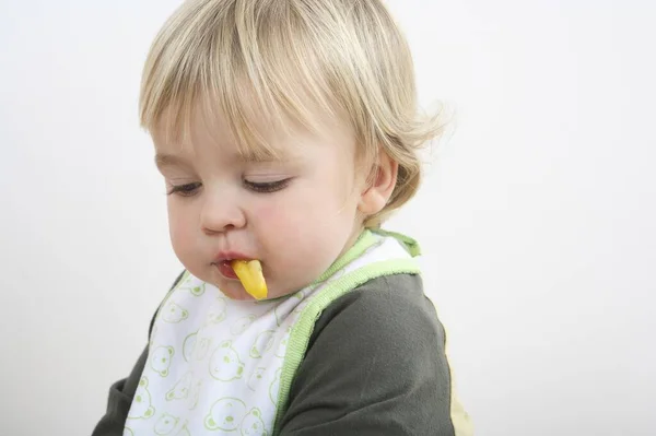 幼児とともに赤ちゃんビブ食べるスライスしたカプセル — ストック写真