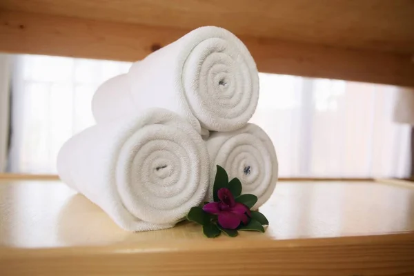 Fresh white towels rolled up close-up view