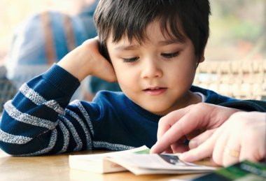 Baba 'nın oğluna kitap okuduğu mutlu yüzlü ve babasıyla kitap okuduğu mutlu bir ailenin birlikte vakit geçirdiği sahneler.. 