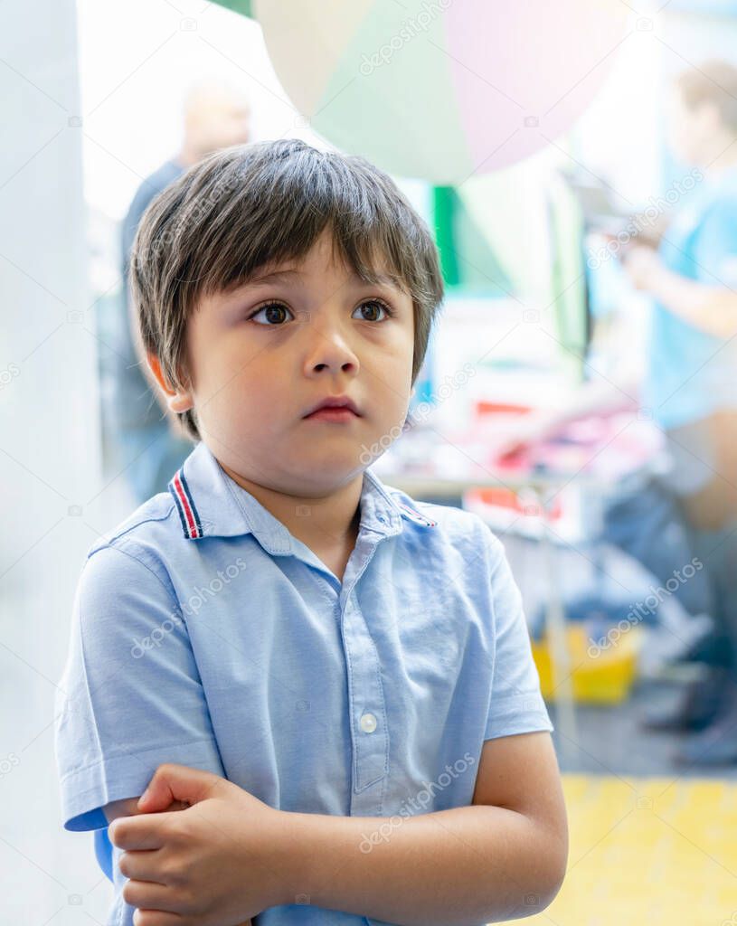 Portrait upset little boy standing alone and start crying at birthday party, Unhappy Caucasian 6 year old child at the party, Lonely kid with bored face, Jealous children concept.