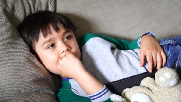 Candid Shot Happy Kid Lying Sofa Watching Living Room Portrait — Stock Video