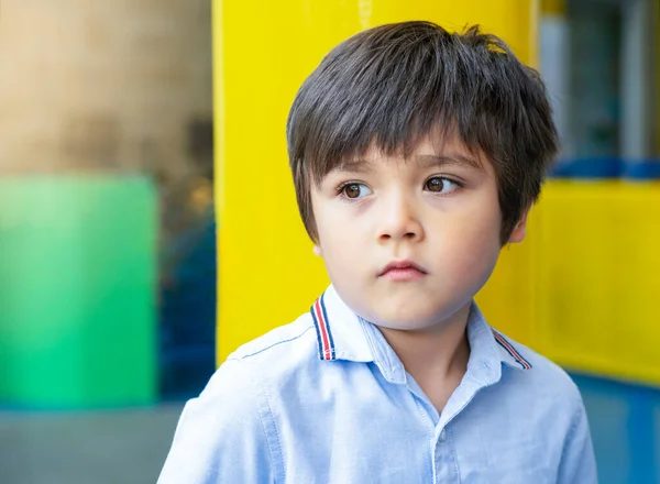 Emotional portrait of Unhappy Toddler boy with sad face, Upset boy standing alone, Kid sad face looking down, Lonely kid with bored face, Spoiled children concept