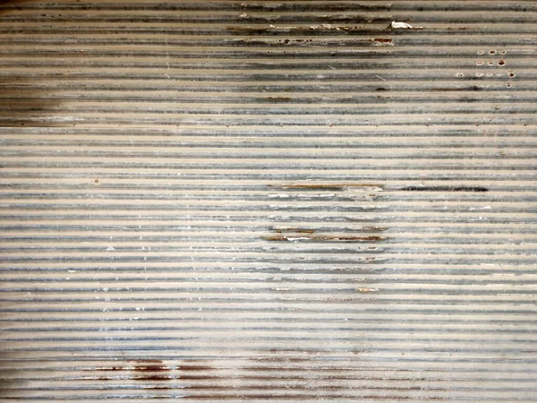 Old zinc wall texture. Garage door close up photo. Horizontal abstract background.