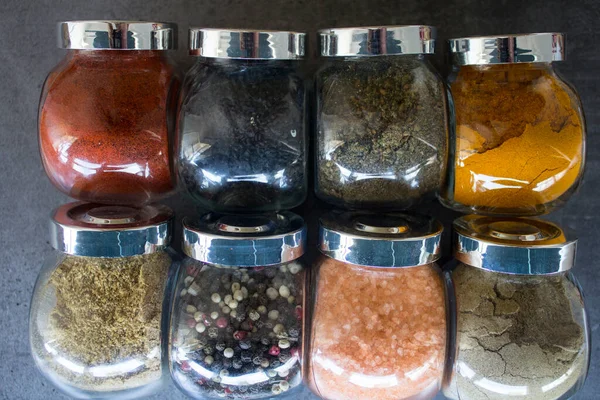 Sortimento Especiarias Coloridas Frascos Vidro Mesa Cozinha Fundo Cinza Escuro — Fotografia de Stock