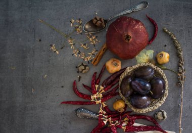 Kurumuş meyveler, otlar ve sebzelerle dolu gri dokulu arka planda fotokopi alanı olan bir hayat. Sonbahar havası düzleşir. 