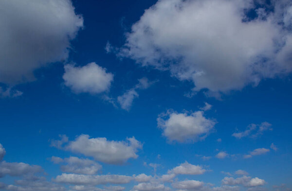 Blue sky with the clouds. Sunny day photo.