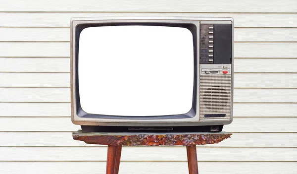 老旧的家用电视接收机 放在白色木墙上的旧木桌上 — 图库照片