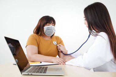 Female doctors use stethoscope to examine the heart of obese female patients. That is at risk for coronavirus infection. The concept of treatment to prevent severe pathogens clipart
