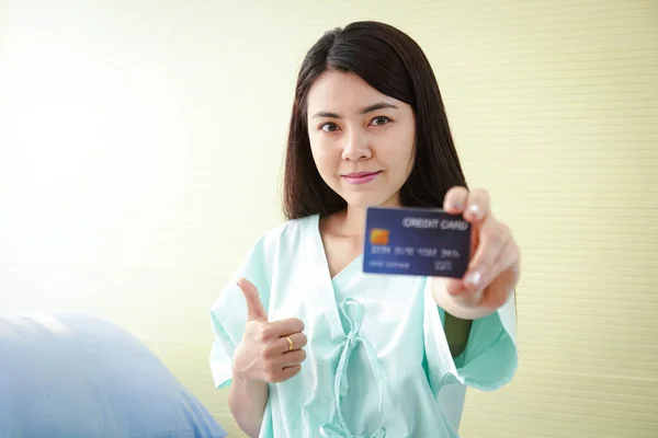 The patient holds a credit card to treat the disease. Get health benefits and more. Credit cards mockup. Hospital service concepts. insurance
