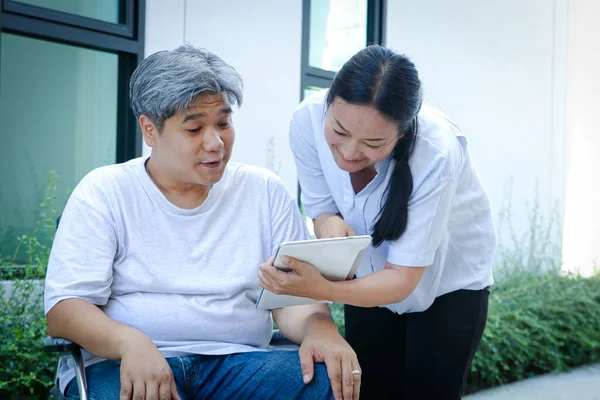Elderly Patient Sitting Wheelchair Taken Care Nurse Look Smiling Tablet — Stock Photo, Image