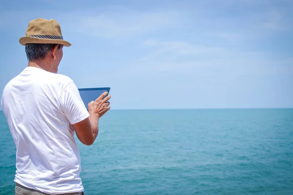 Homem Idoso Asiático Praia Segure Tablet Jogar Internet — Fotografia de Stock