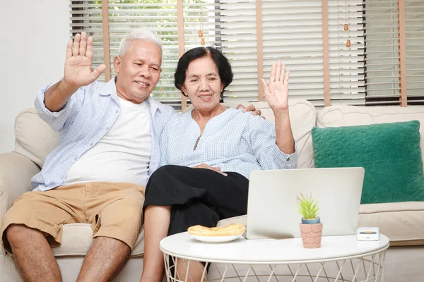 Elderly Asian Couple Sitting Living Room Raise Your Hand Greet — Stock Photo, Image