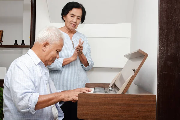 Senior Asian elderly couple Have fun playing the electric piano together. Senior Community Concept, Health care