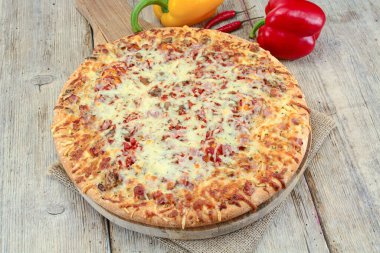 Tahta arka planda peynirli pizza.