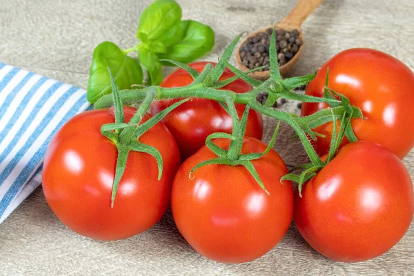 bunch of tomatoes and basil on a table