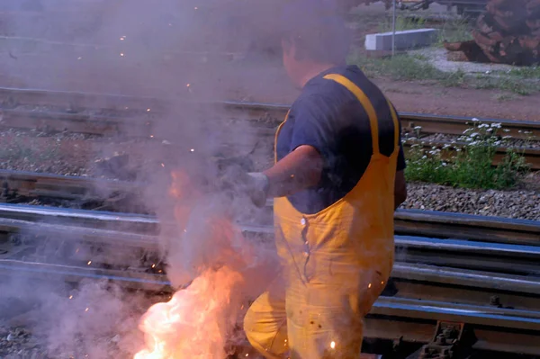 Repair work on the rail network, worker with welding machine