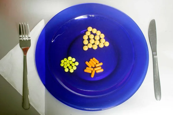 Medicamento Plato Azul Con Diferentes Píldoras Junto Tenedor Cuchillo Servilleta —  Fotos de Stock