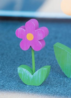 Bardaktaki ahşaptan yapılmış pembe bir çiçek.