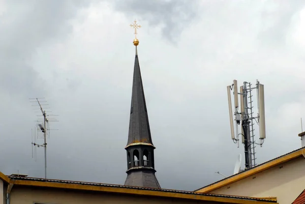 Mobile phone mast and antennas on the roof of a building in the city