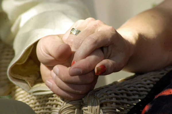 two people holding their hands, symbol for familiarity and affection