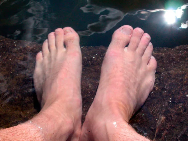 with bare feet in the water, barefoot on a summer day