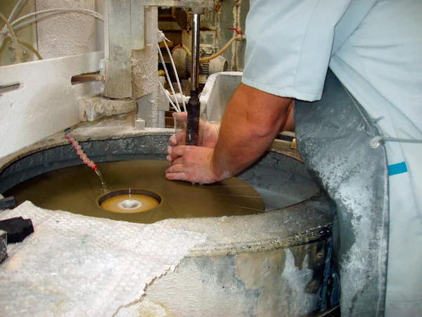 glass grinding with water at a glaziers workshop, handicraft business