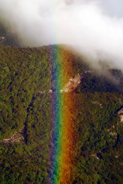 rainbow over a forest in the mountains, view from above