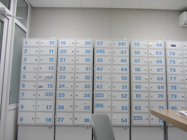 room with safe deposit boxes or safe deposit lockers, blue numbers on gray boxes