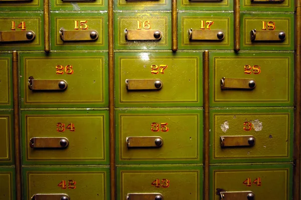 safe deposit box or safe deposit locker, golden numbers on old green boxes