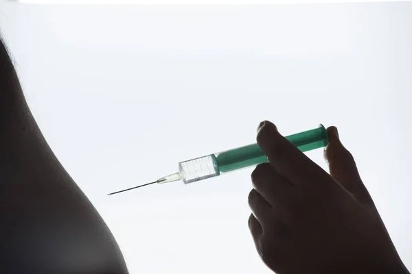 vaccination by injection with a syringe, protection against dangerous diseases