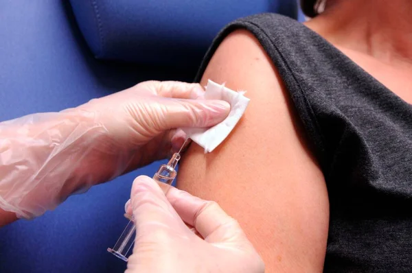 vaccination by injection with a syringe, protection against dangerous diseases