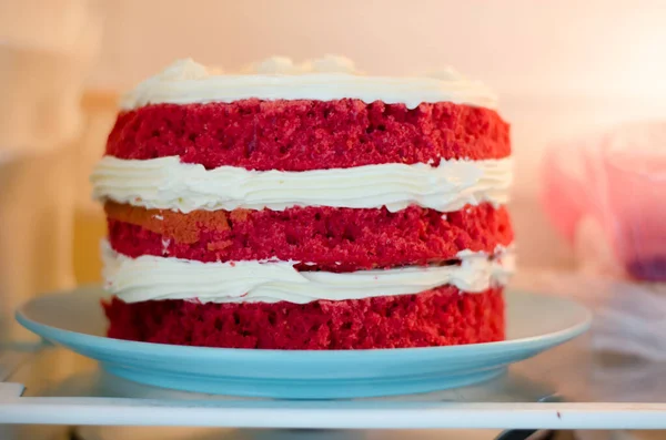 The red velvet cake is on the shelf in the refrigerator. Home-made red velvet cake