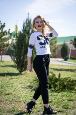 Doğada poz veren genç bir kız. Manken sarışın. Dikey fotoğraf