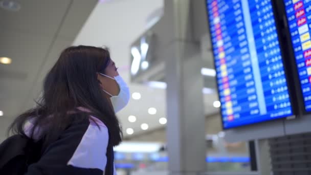 Asiatisk Kvinnlig Transfer Passagerare Bära Skyddsmask Monter Tittar Avgång Tidtabell — Stockvideo