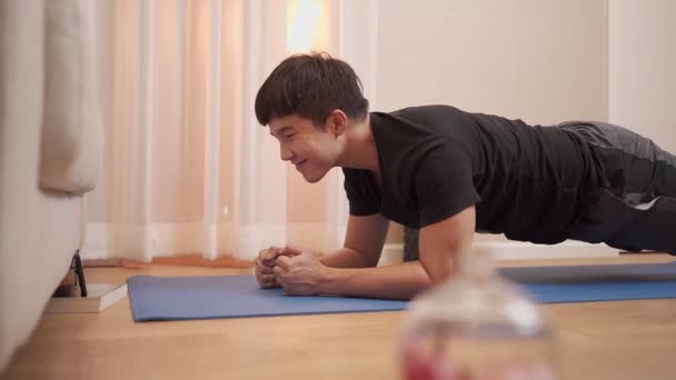 Asian Young Man Planking Watching Smartphone Same Time Exercise Covid — Stock Video