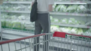 Corona virüsünün markette ekonomik etkisi, sebze tedarik eden kadın, süpermarketteki buzdolabı rafları, gıda stoğu, covid-19 salgını, kalori eksikliği tüketimi