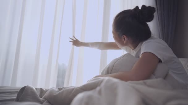 Young Asian Woman Wakes Open Curtains Enjoying Warm Morning Sunlight — Stock Video