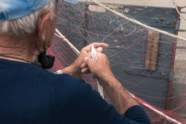 Rybář opravuje rybářskou síť — Stock fotografie