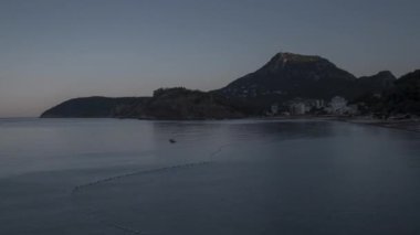 Sutomore, Karadağ sahil beldesinde gün doğumu. Terminatör dağlar ve deniz arasında hareket ediyor. Zaman atlamalı 4k, 3840x2160.