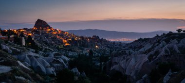 Uchisar kalesinin panoramik manzarası gece Kapadokya, Orta Anadolu, Türkiye, Asya 'da. Panoramik pankart bölümü
