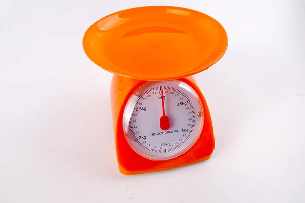 A Orange colour weight measurement balance isolated white background