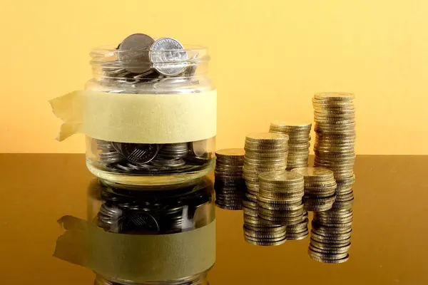 Saving Concept Coins Stacked Mason Jar Yellow Background — Stock Photo, Image