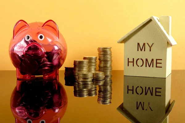 Saving Concept Red Piggy Bank Coins Stacked Small House Yellow — стоковое фото