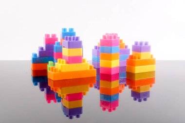 Plastik yapı taşları yansıması ile beyaz arka plan üzerinde izole.