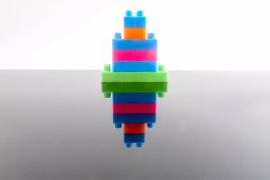 Plastik yapı taşları yansıması ile beyaz arka plan üzerinde izole.